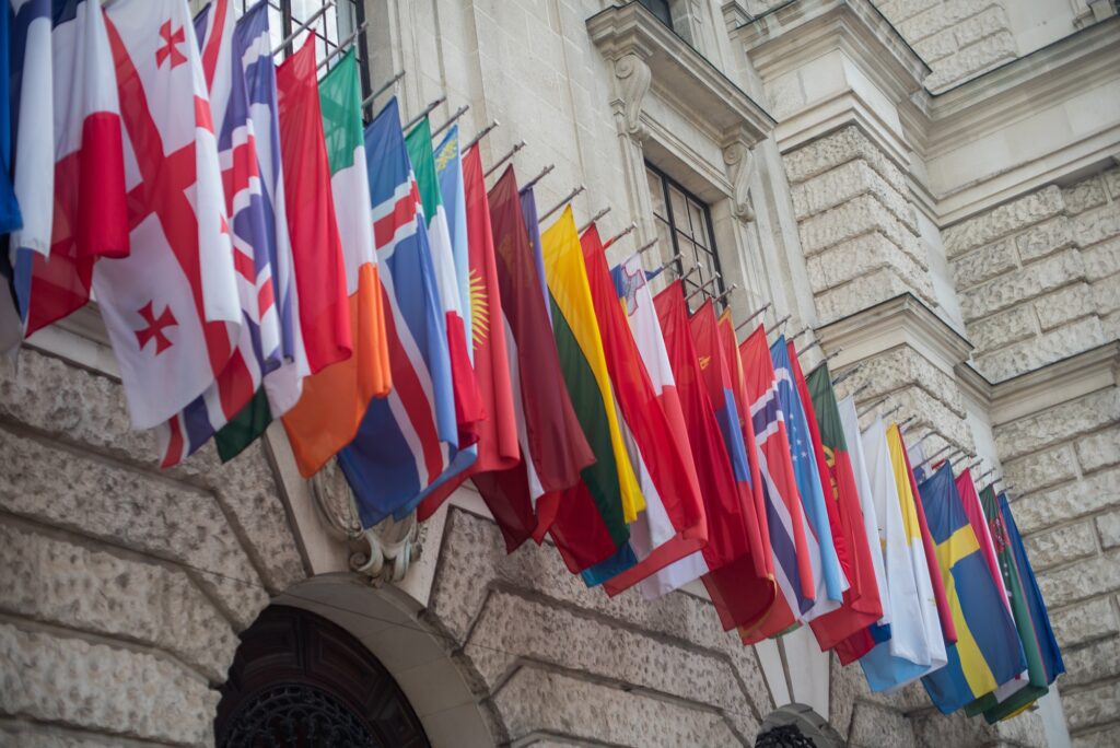 assortment of various countries flags seen on balcony of building