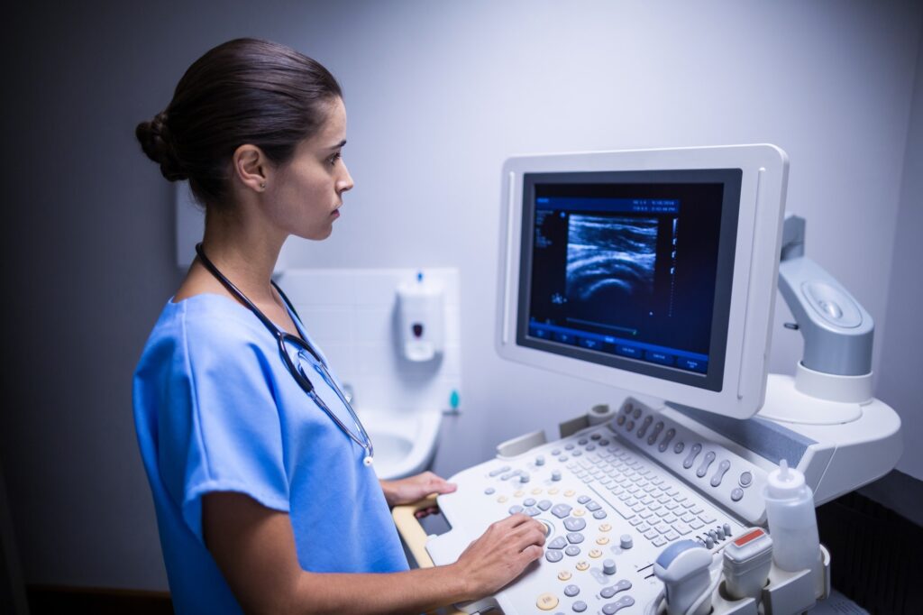 Nurse examining ultrasonic monitor