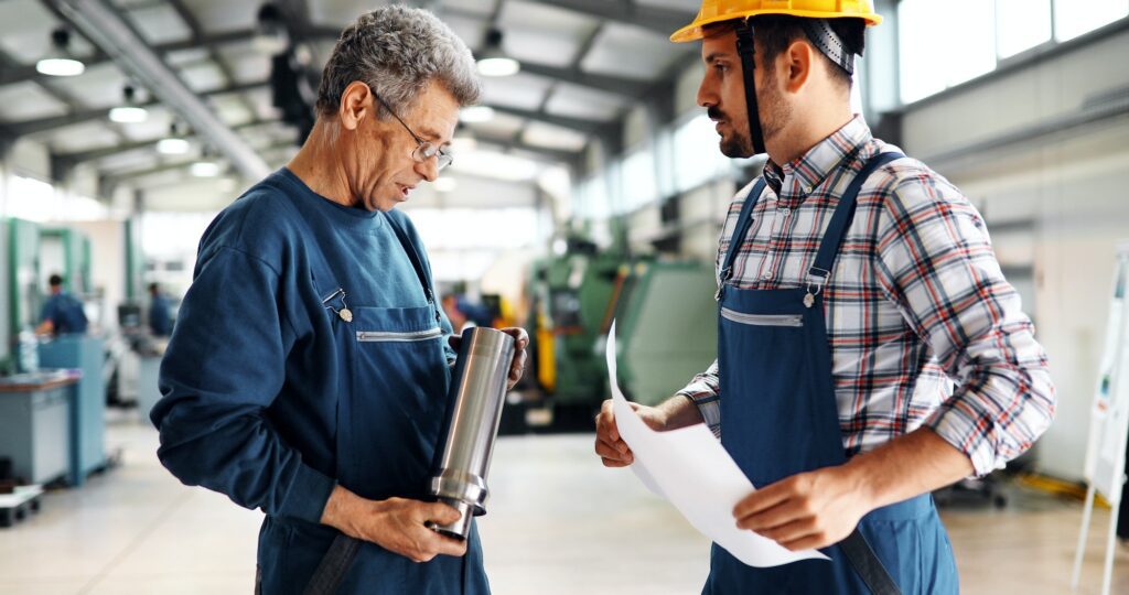 Team Of Engineers Having Discussion In Factory