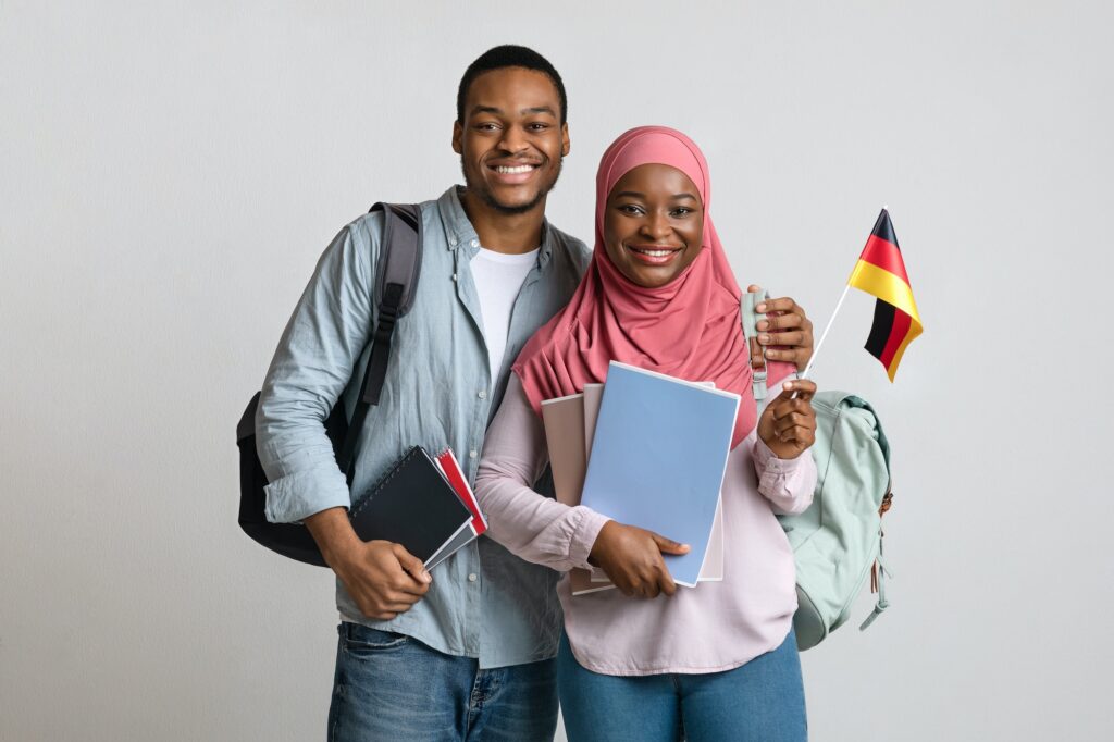 Cheerful african american muslim students couple holding german flag