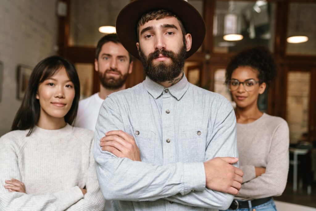 Image of multiethnic young business workers standing together at office