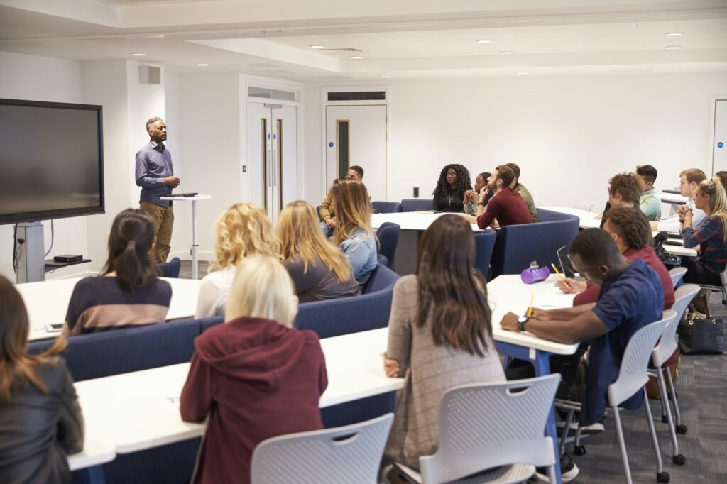 University students study in a classroom with male lecturer